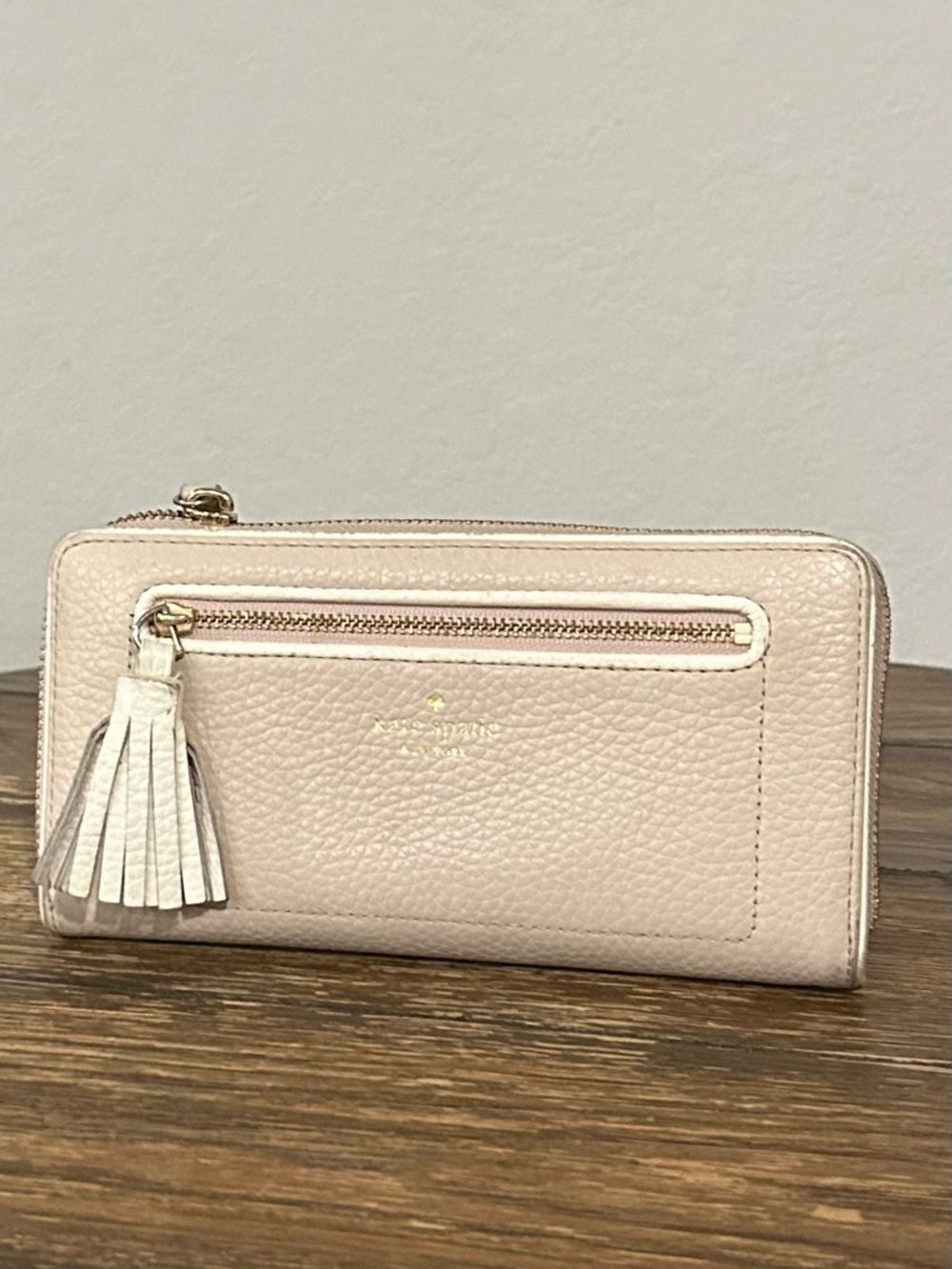 kate spade Pebbled Leather Tassel Zip Wallet in cream